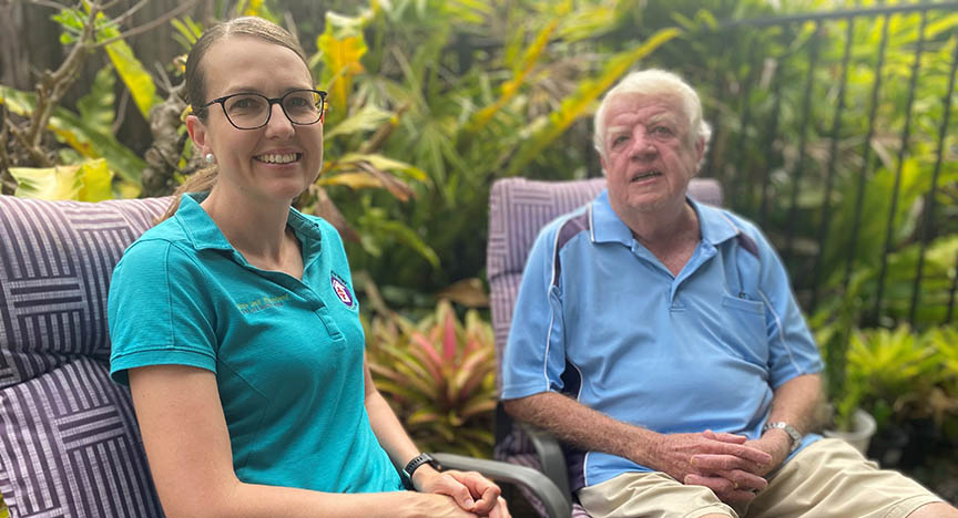 Clinician and patient sitting in backyard together