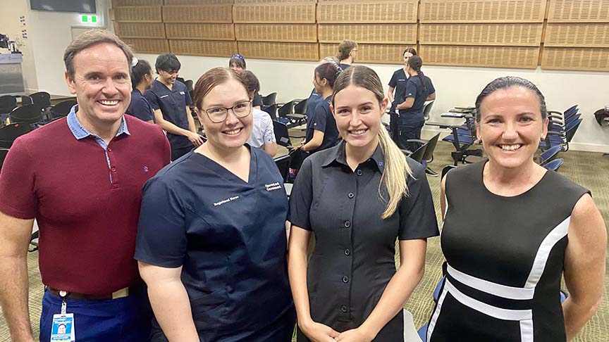 Two young female nurses (Stephanie and Analiese) standing between a man (Cameron Duffy, Executive Director of Nursing and Midwifery) and woman (Tracey Bancroft, Nursing Director Strategic Planning and Workforce)