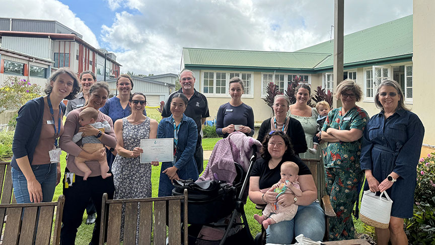 Group photo of staff, mothers and babies at Atherton Hospital